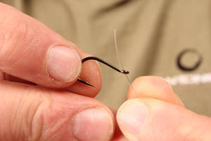 1. Start off by threading the Trip-Wire through the eye of a Chod Hook this way.