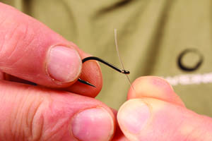 Step 1. Start off by threading the Trip Wire through the eye of a Chod Hook this way