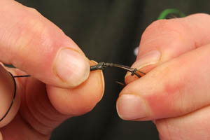 Step 6. Push the tubing up over the eye of the hook so 2 or 3 mm are below the hooks eye...