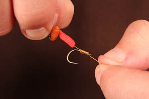 Step 3. Add a hair stop to keep the bait in place. Using a simple knotless knot whip down the hook shank. We prefer a short hair.
