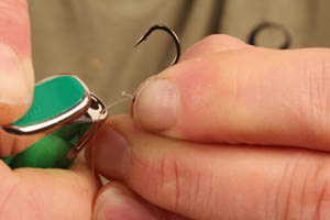 Use a lighter to carefully burn back the tag to create a blob of melted hooklink.