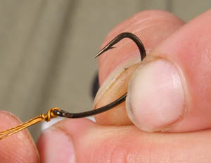 Step 2 - Neatly bed down the knot and cut off a short 4 inch length of braided hooklink.