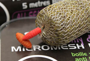 Step 5 - Thread a PVA Micromesh stick of groundbait down the hooklength and carefully push the hook point into the bag.