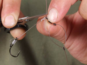 Tie on Trip wire hook section with three turn blood (prior to blobbing and seating down tight to the swivel eye).