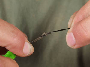 Add a large Covert rig ring (3mm) onto the pop up hook aligner and thread onto hooklink using a lead core splicing needle.