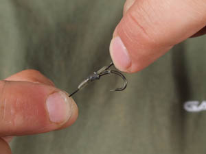 Push up onto hook and position the hook aligner as shown with the D sat straight on the back of the hook shank.