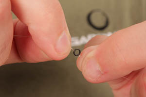 Step 2. Tie the mainline and the weak lead link to a Large Covert Rig Ring.