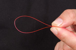 Step 2. Form a loop in a strong monofilament, we have used red line for clarity of the photos, but recommend Mono or Fluorocarbon hooklinks of at least 15lb.