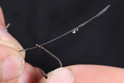 Step 4. The loophair should be positioned like this, allowing the right length for the hair. The hookbait should just touch the bend of the hook when finished.