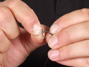 Step 5. Thread a large Covert Rig Ring onto the tag left from the knotless knot. You will attach your hookbait to this rig ring later.