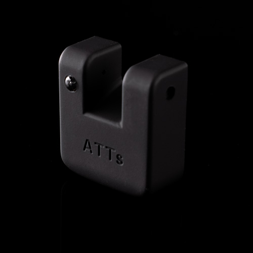 A small, black, U-shaped plastic ATTci Replacement Back Plate with "ATTs" embossed on the front, photographed against a black background.