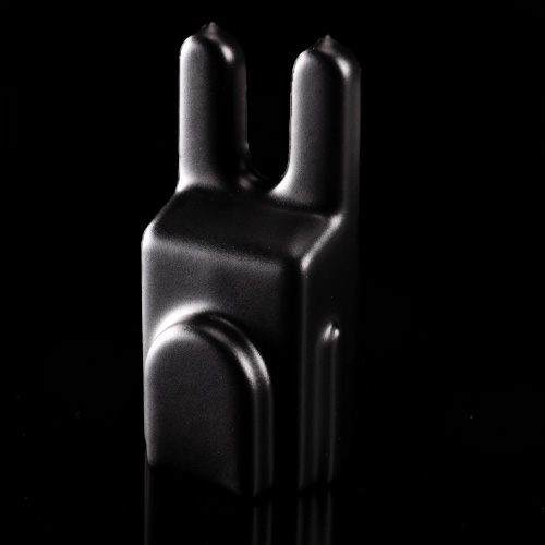 The ATTci Replacement Back Plate is a matte black, minimalist accessory with a blocky shape and two upright sections, photographed against a solid black background.