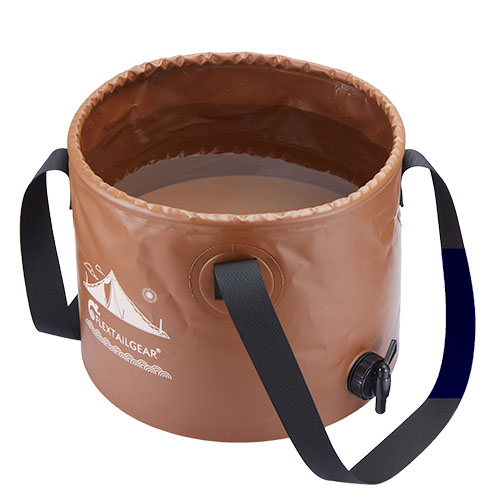A brown, collapsible Flex Bucket with black handles and a bottom spout, partially filled with water. Camping graphics and "FLEXTAILGEAR" are printed on the side.