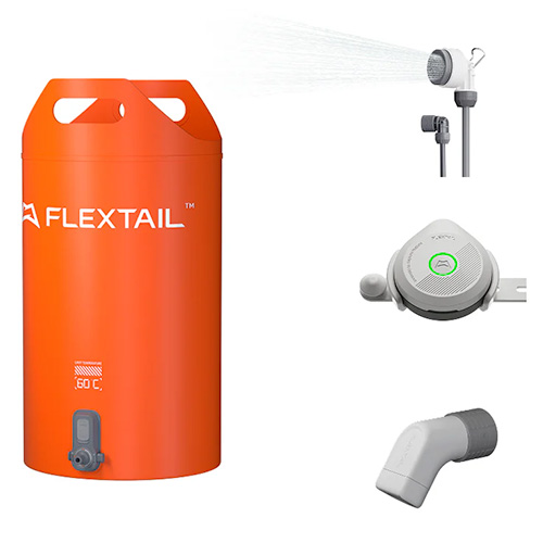 An orange Tiny Shower Bucket by FLEXTAIL with a spout, shown with a showerhead spraying water, a round control device, and a white angled connector attachment.